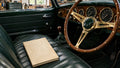Illustrative book in a classic-car cockpit; digital PDF guide, no physical book supplied