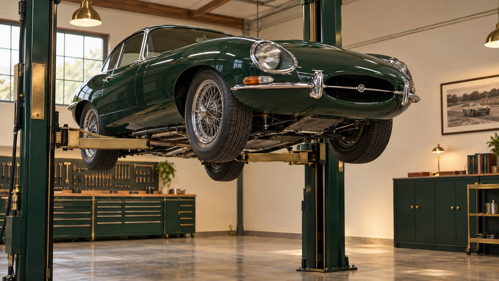 Illustrative Jaguar E-Type on a workshop lift
