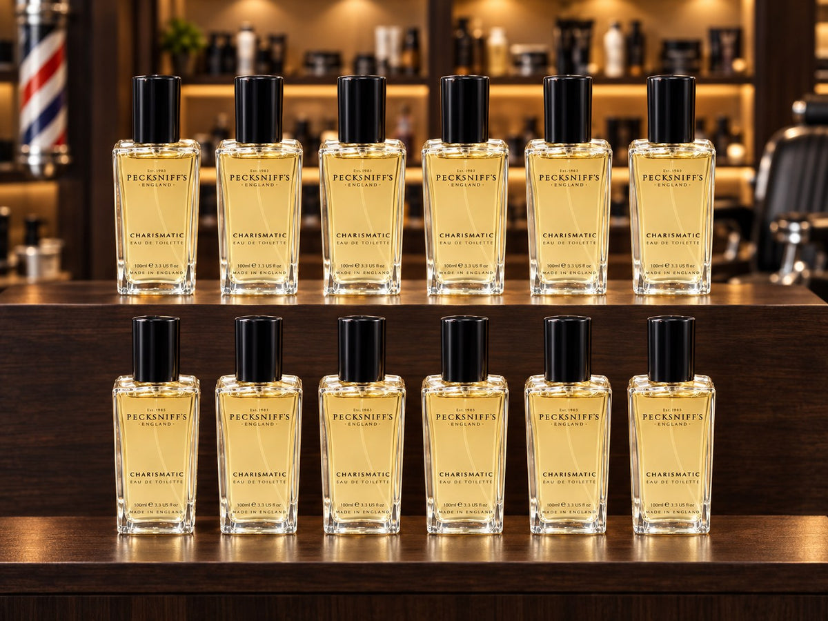 Twelve Charismatic EDT bottles on a barbershop counter (styled image)