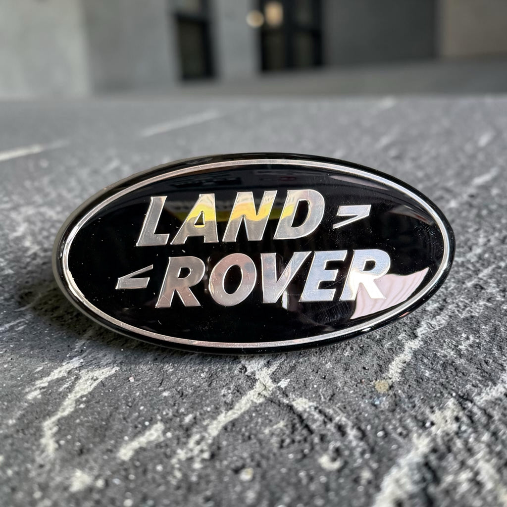 Land Rover oval badge angled view showing chrome rim