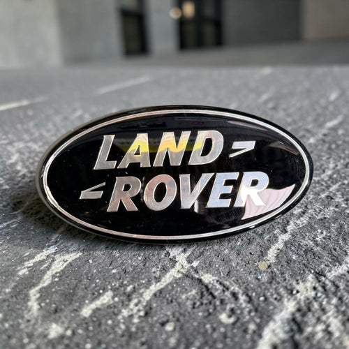 Land Rover oval badge angled view showing chrome rim