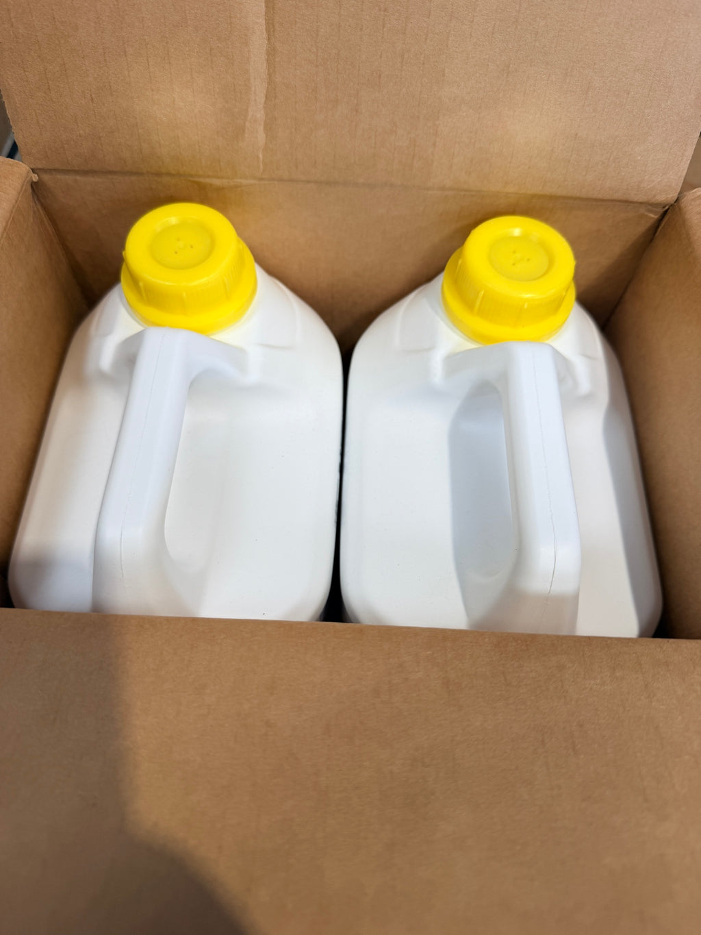 Oxivir Excel case opened showing two sealed 5L canisters