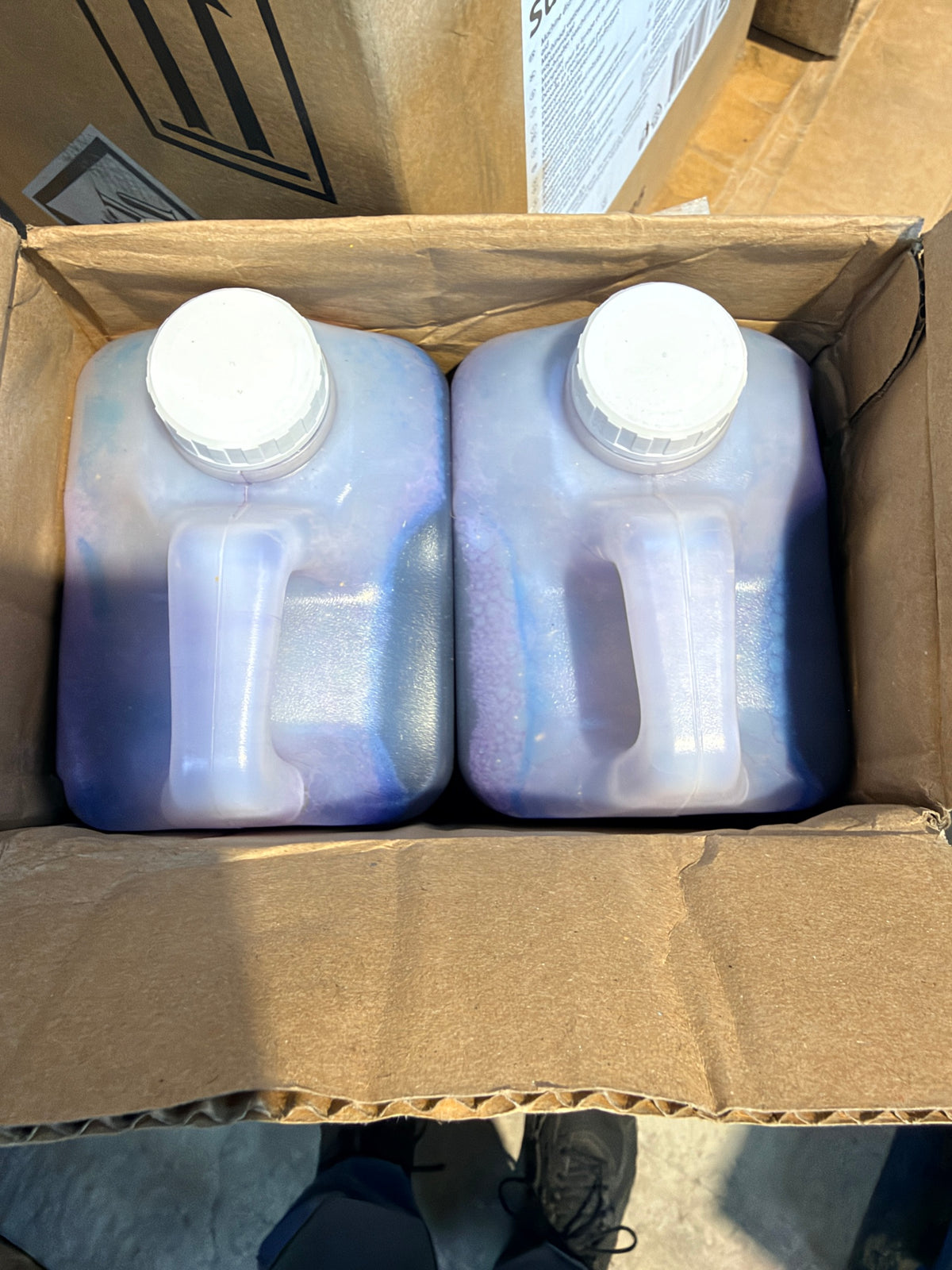 SA41 case opened showing two sealed 2L bottles