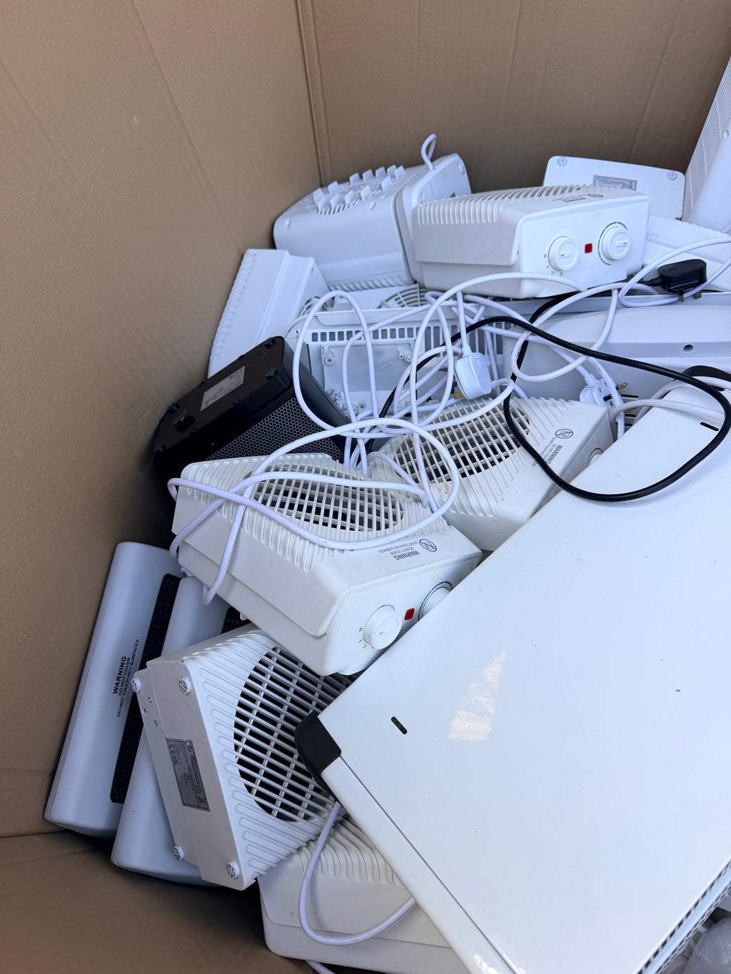 Close-up of loose white fan heaters and cables