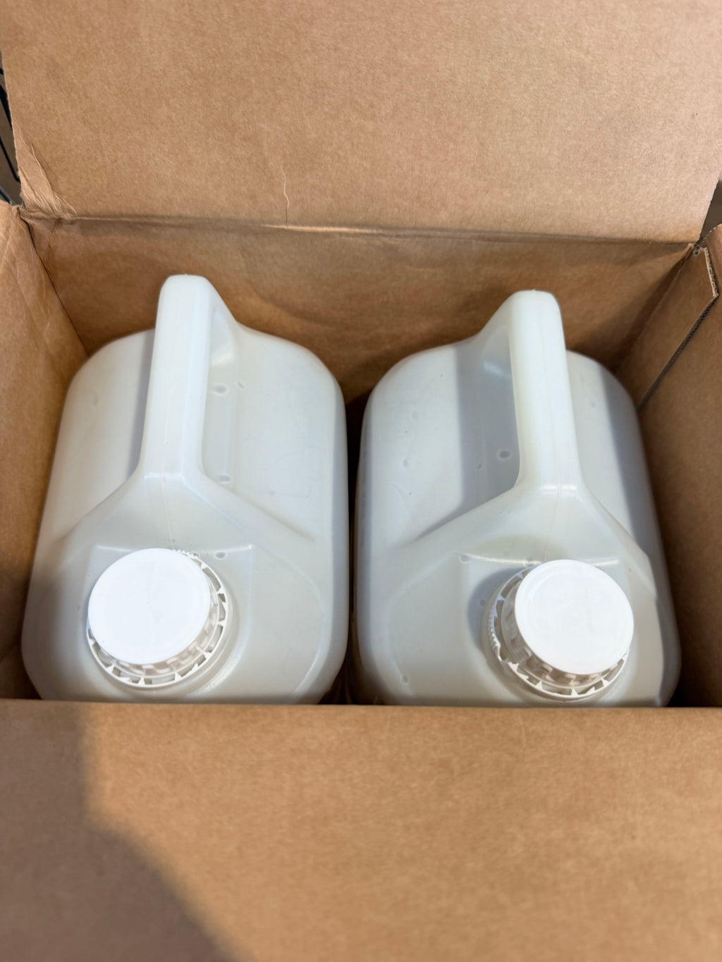 Suma Nova Pur-Eco L6 case opened showing two sealed 5L canisters