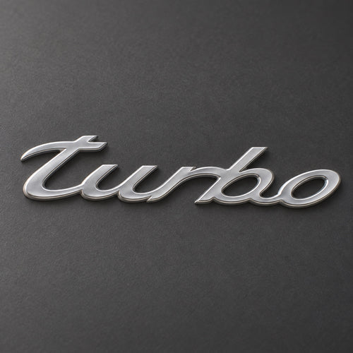 Silver-coloured aftermarket turbo script badge