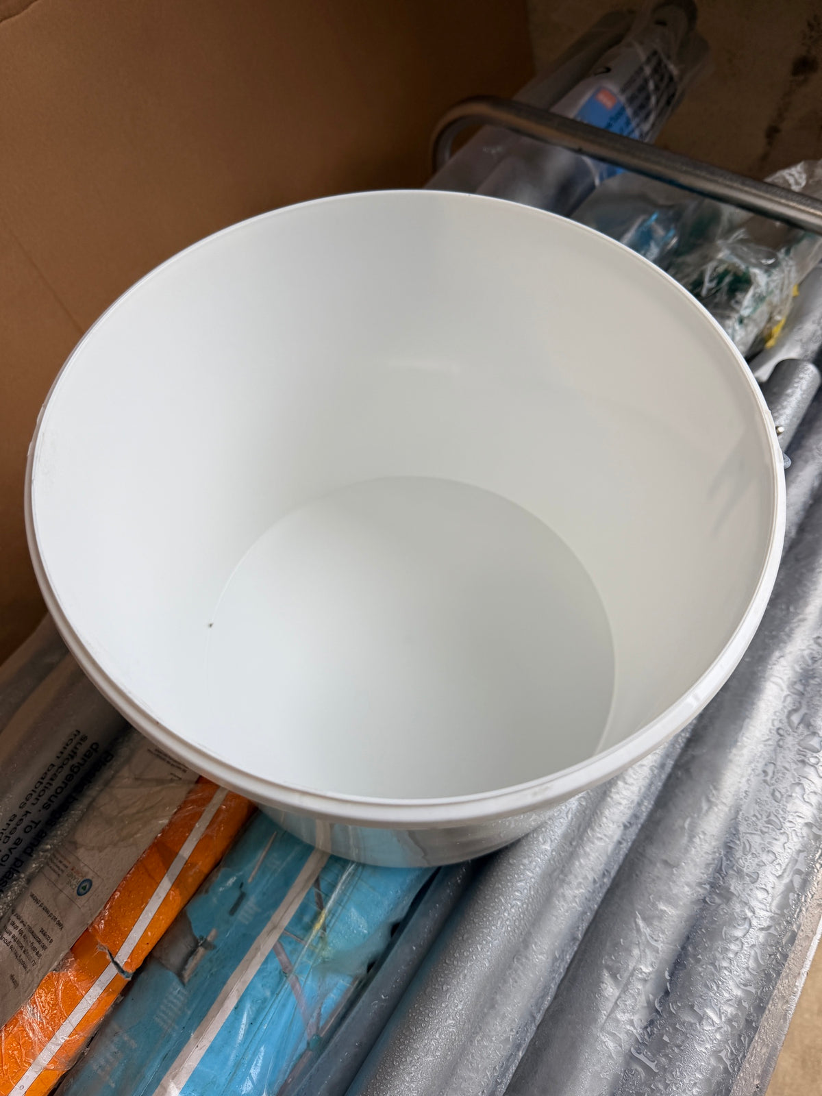 Inside of a new white plastic bucket