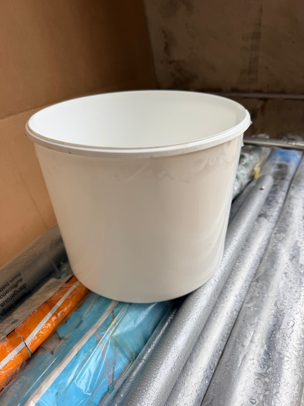 Side view of white plastic bucket