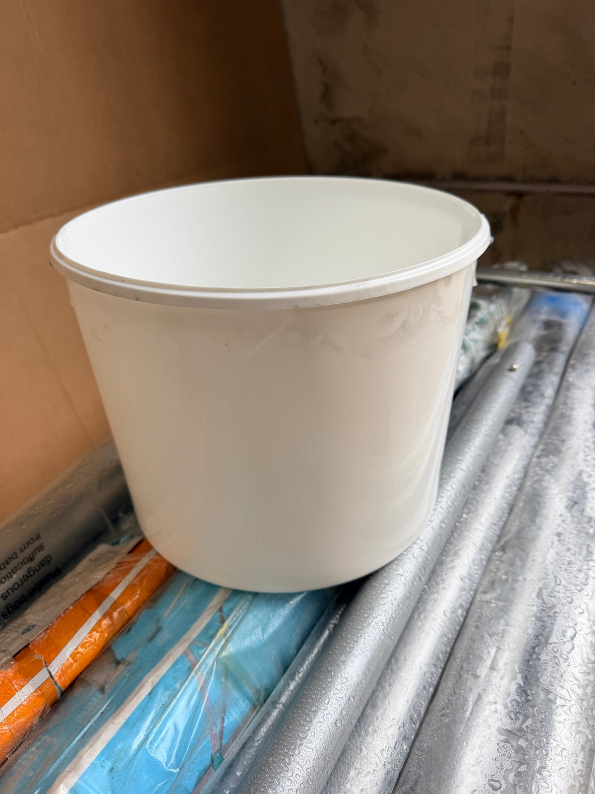 Side view of white plastic bucket