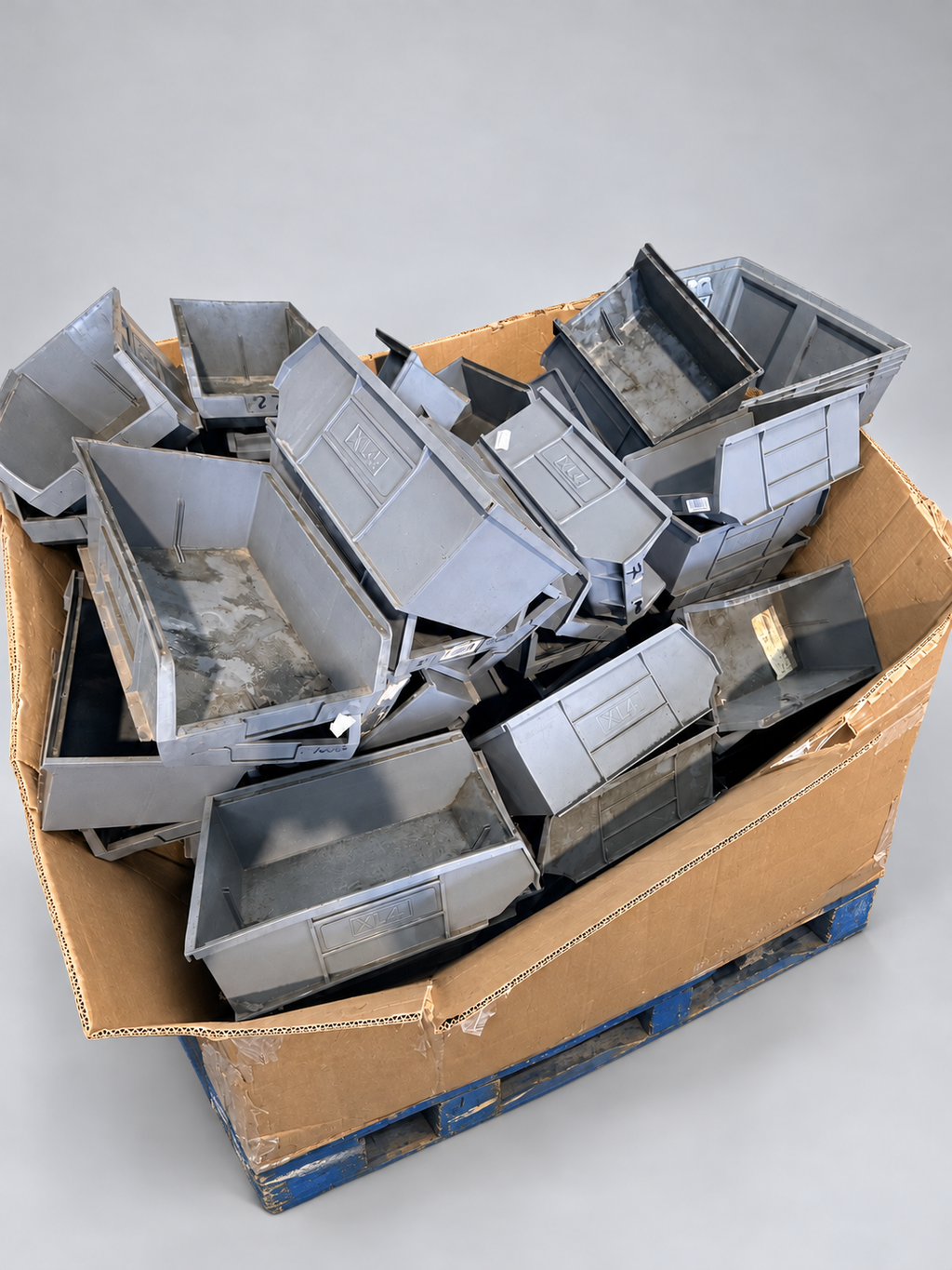 Box pallet of used grey XL4 picking bins – studio background, bins as photographed